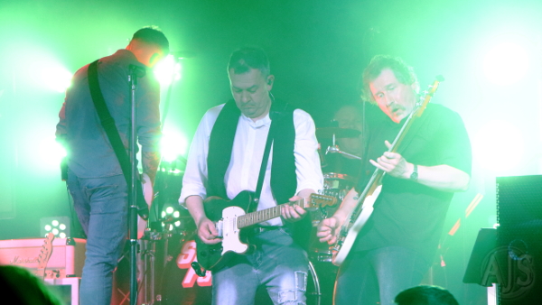 The band performing on a dry ice filled stage.