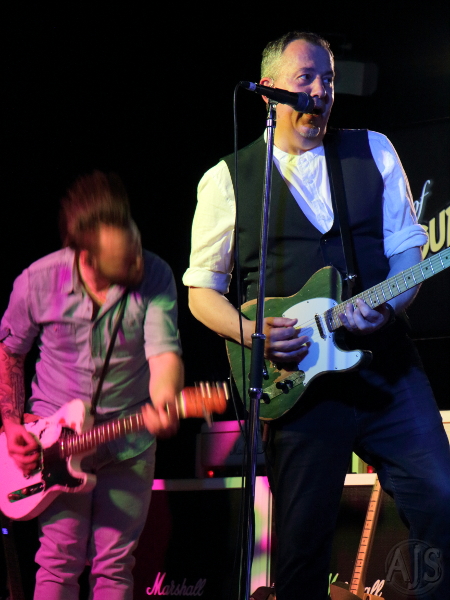 Two Status Faux guitarists, one head banging.