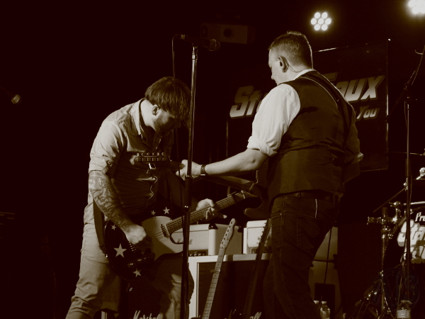 Guitarists on stage.