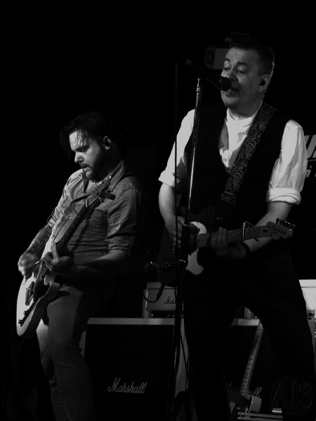 Status Faux front men performing.